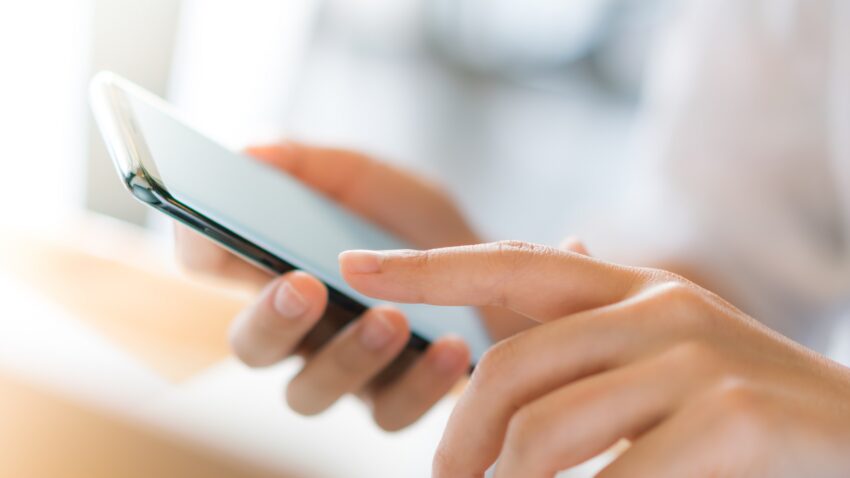 Business hand with mobile phone .